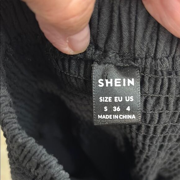 Black Ruffle Hem Wide-Leg Gaucho Pants. Elastic waist and ruffle hemline - Picture 6 of 11